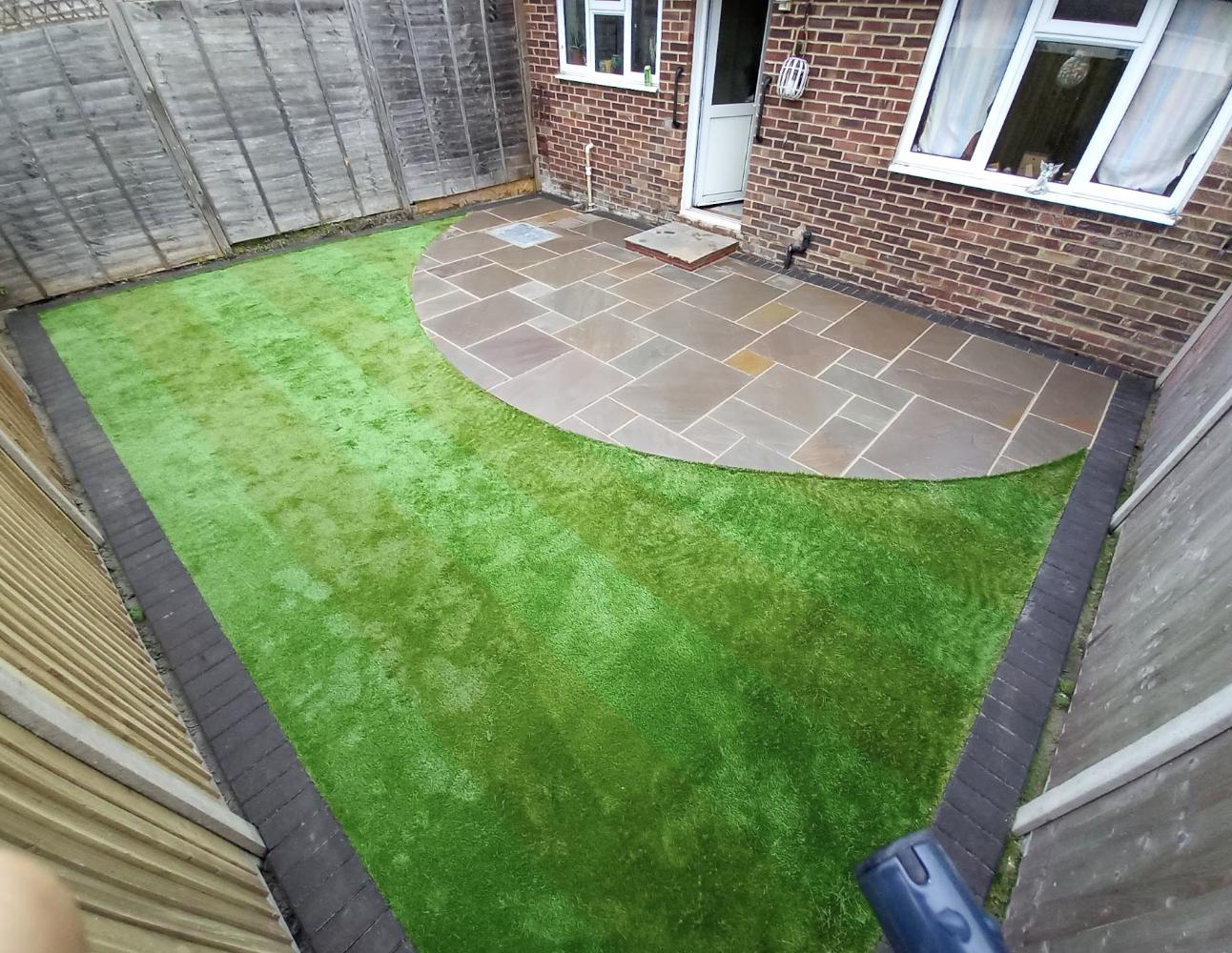 Garden mid renovation with turf being laid and beds dug