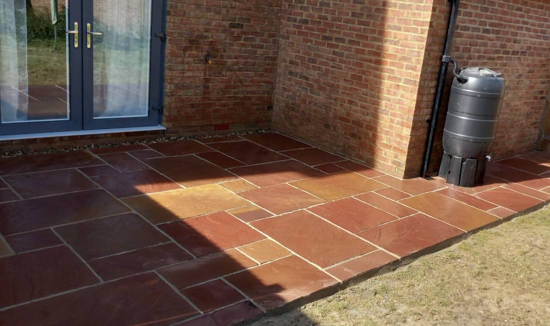 Terracotta Indian sandstone patio laid at french doors, Kent