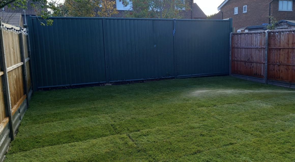 New turf and green metal boundary after a full garden transformation, Folkestone